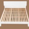 A white bed frame with wooden slats on the bottom.