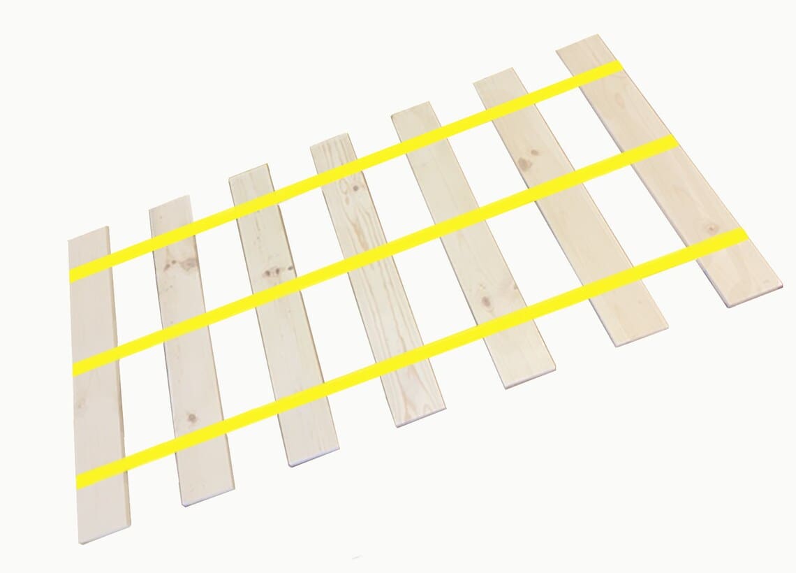 A wooden rail with yellow tape on it.