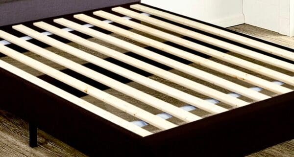 A close up of the slats on a bed frame