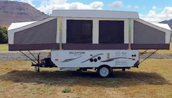 A small trailer with a large window in the back.