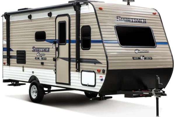 A small travel trailer parked in the street.