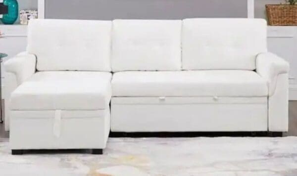 A white couch sitting on top of a floor.