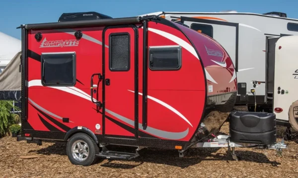 A red and white trailer with a person standing next to it.