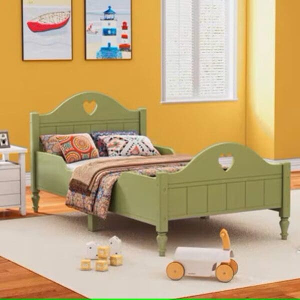 A green bed with heart shaped headboard and footboard.