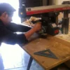 A man using a drill to make something