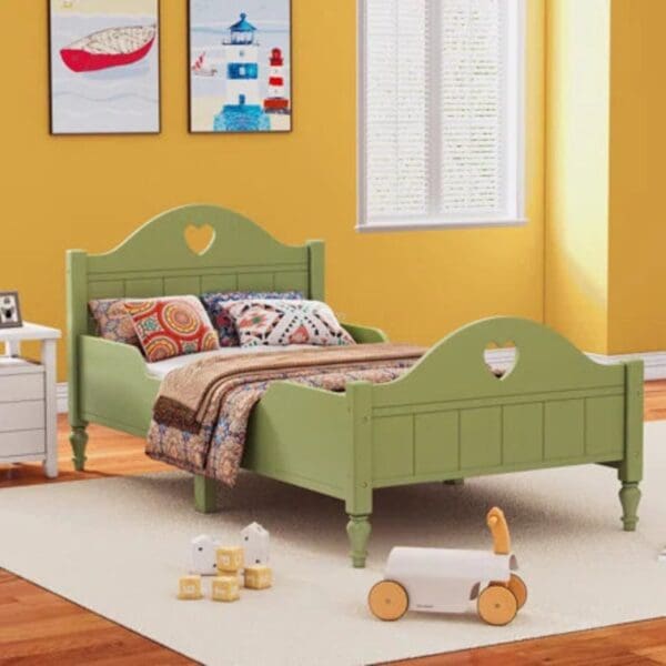 A green bed with heart shaped headboard and foot board.