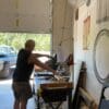 A man in a garage with a table saw.