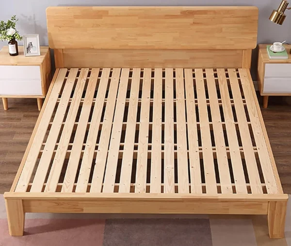 A bed frame with wooden slats on the bottom.