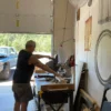 A man standing in front of a table with a saw.