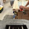 A person using a power tool on wood.