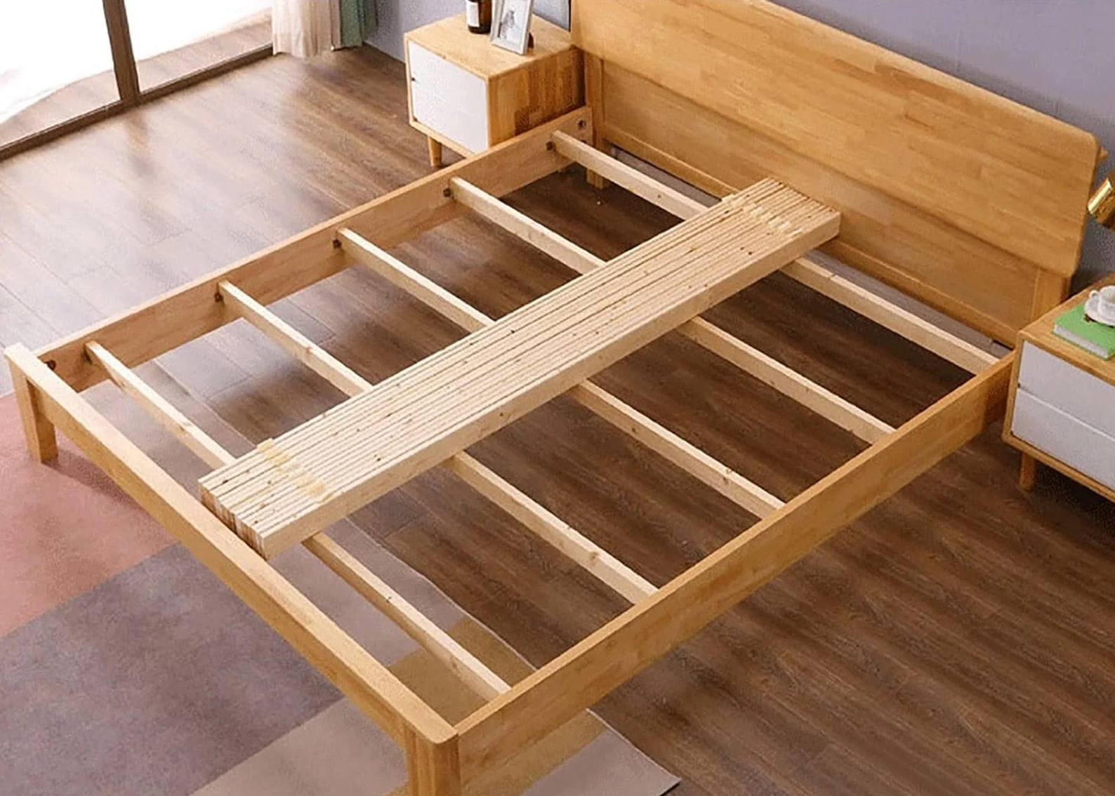 A bed frame with wooden slats on it.