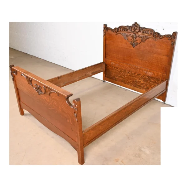 A wooden bed frame with an ornate headboard.