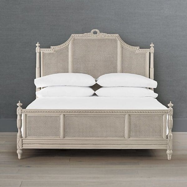 A bed with white sheets and headboard