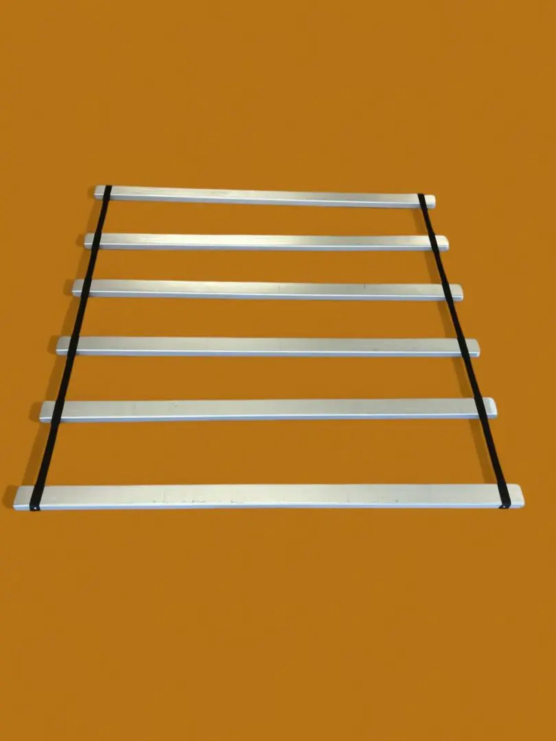 Here's an alt tag for the image: Metal slatted frame with straps.