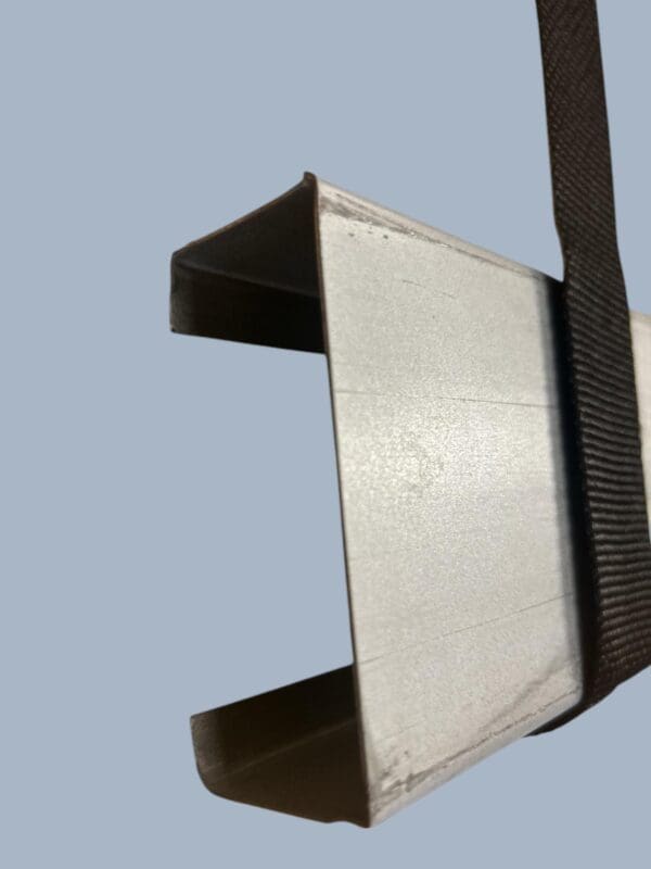 Metal channel with hanging strap.